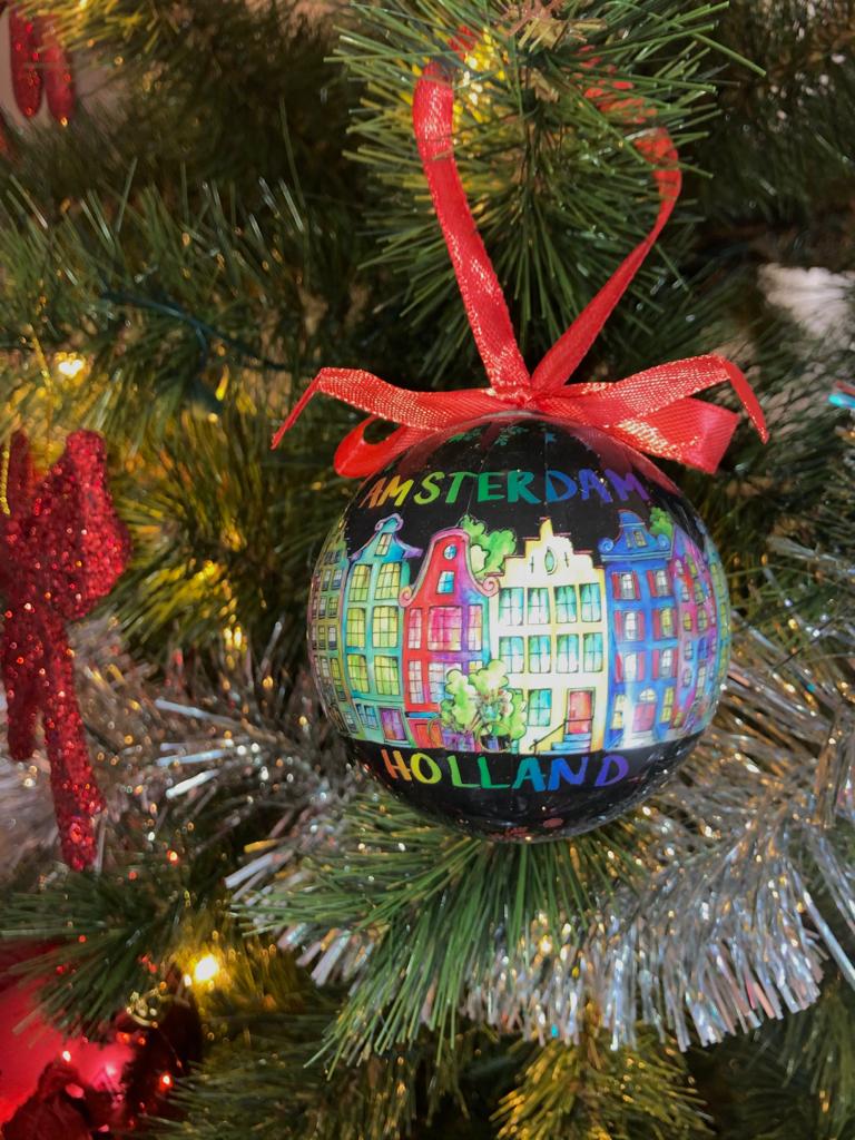 Trek je kerstboom uit de kast en versier je kerstboom met alleen de mooiste kerstballen. Deze zwarte bal past perfect in combinatie met andere kleuren. Een erg mooie bal met "Amsterdam Holland" erop geprint. Rondom de hele kerstbal zijn de iconische Amsterdamse grachten te vinden. En als kers op de taart staat "Merry Christmas" ook op de bal geschreven.