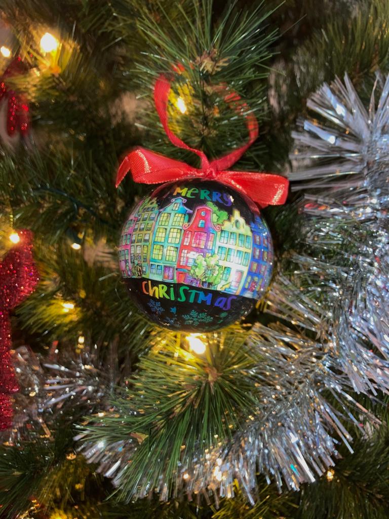 Trek je kerstboom uit de kast en versier je kerstboom met alleen de mooiste kerstballen. Deze zwarte bal past perfect in combinatie met andere kleuren. Een erg mooie bal met "Amsterdam Holland" erop geprint. Rondom de hele kerstbal zijn de iconische Amsterdamse grachten te vinden. En als kers op de taart staat "Merry Christmas" ook op de bal geschreven.